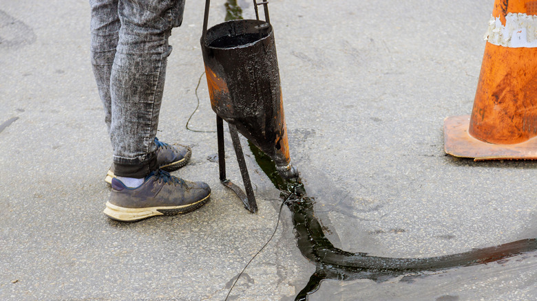 Person repairing concrete driveway