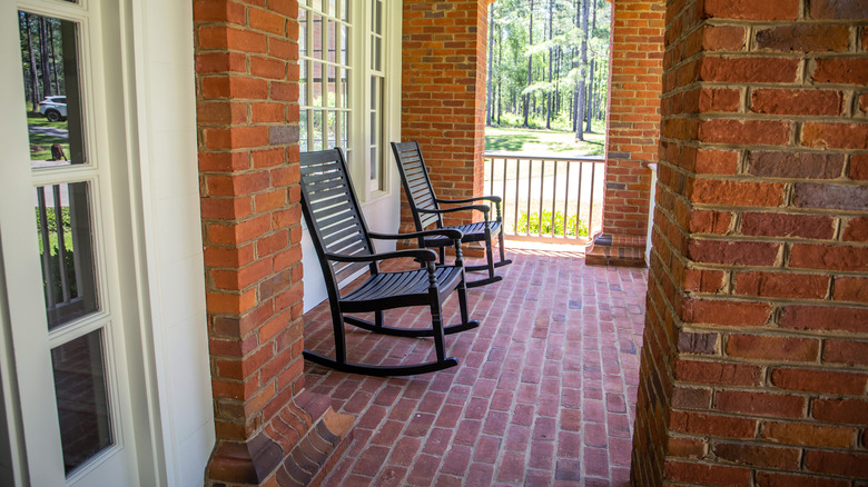 Vintage brick paver front porch with brick columns and rocking chairs