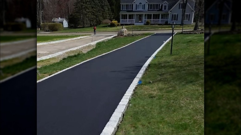 Brand new asphalt driveway with Belgian block edging