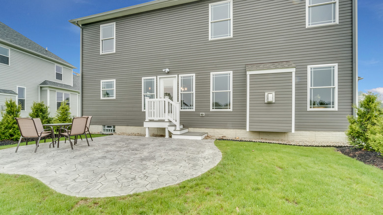 A concrete patio in residential backyard