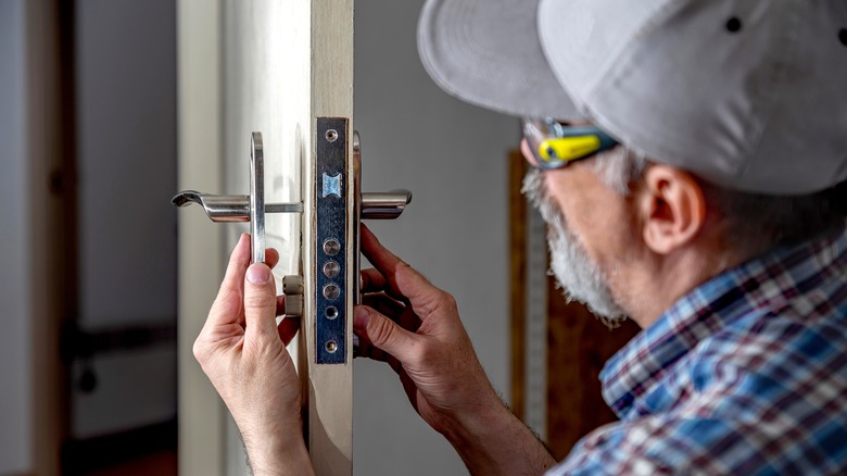 Man installing door hardware