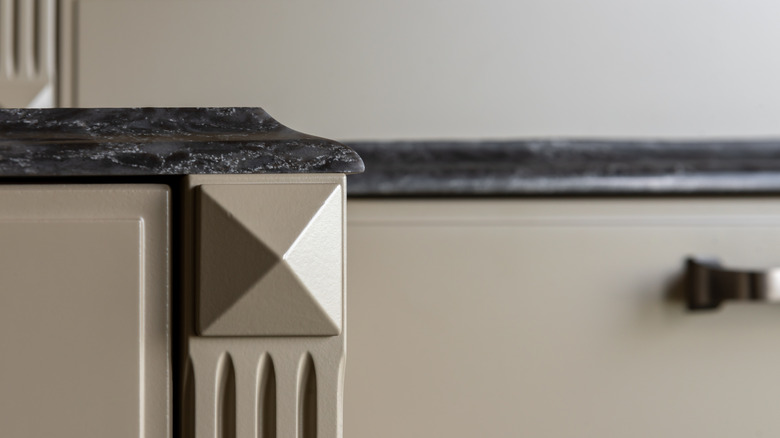 A close-up of dark gray countertops with an ogee edge.