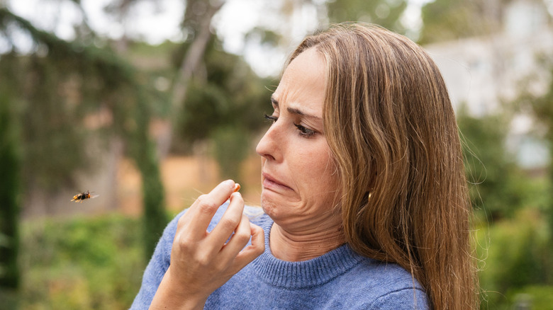 Woman alarmed by outdoor bug