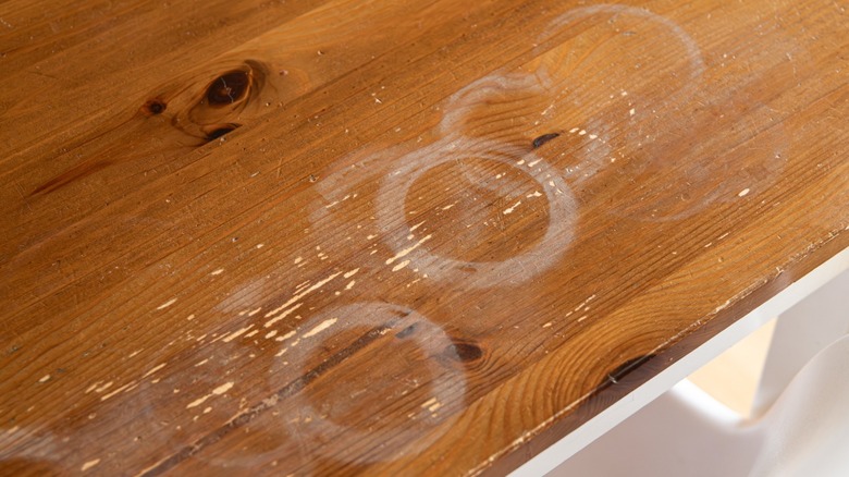 Wooden table with white water ring stains.