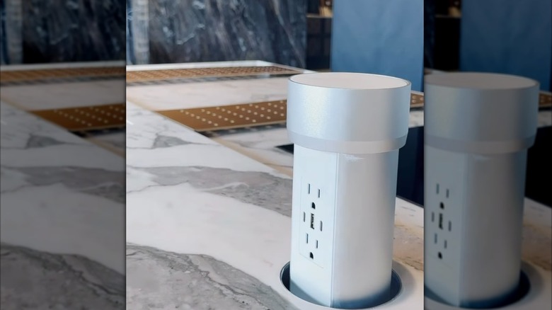 a circular pop-up island outlet receptacle