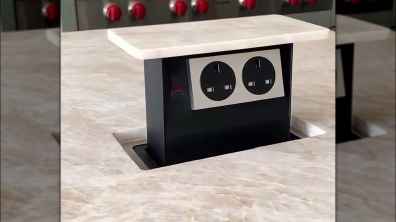 a pop-up outlet receptacle on kitchen island