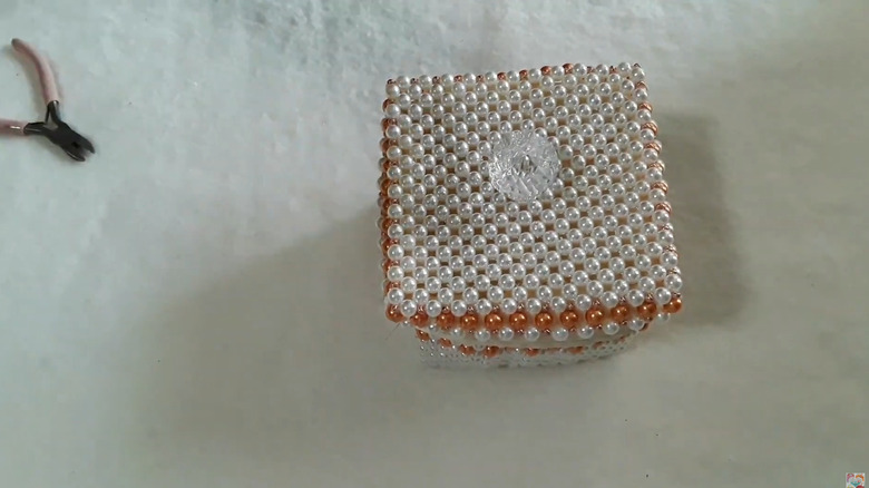 A jewelry box made from beads and cloth
