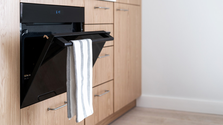 Kitchen towel draped from the oven bar.