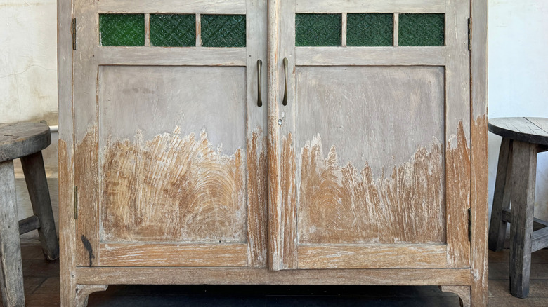 Lower portion of a vintage cabinet with naturally aged paint
