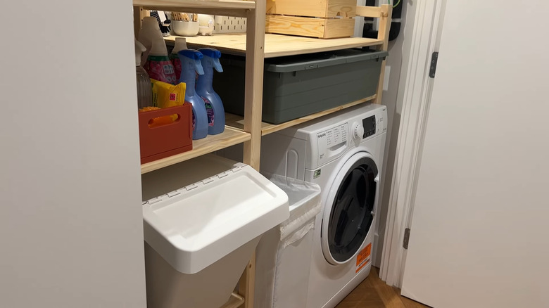 Laundry room items and appliances stored inside an IKEA IVAR storage system.