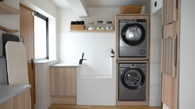 A washer and dryer in IKEA PAX wall-mounted storage units.
