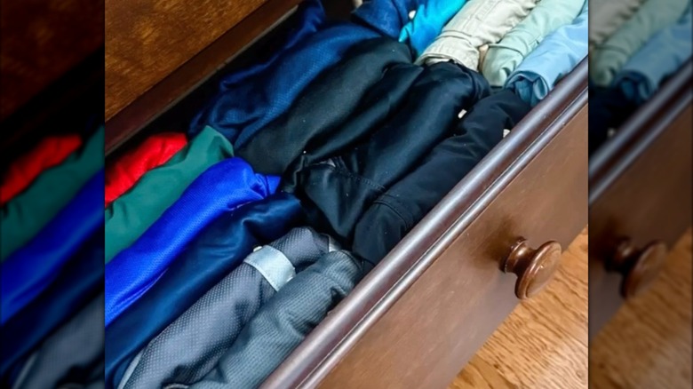 Shirts nicely folded and organized in a dresser drawer using OSTBIT