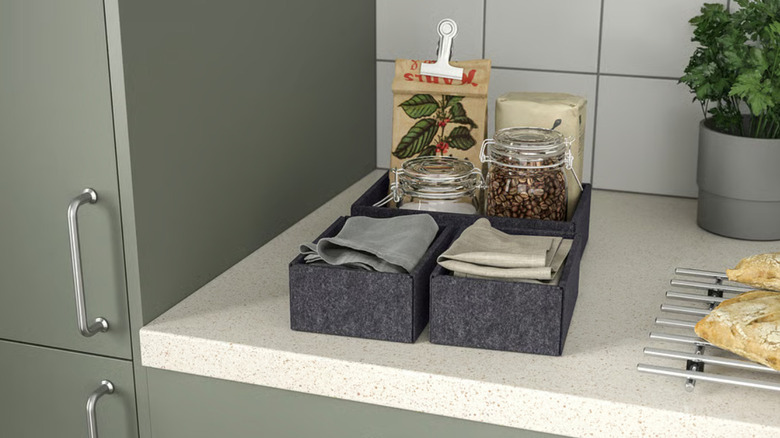 Four polyester UPPDATERA boxes on a kitchen counter with