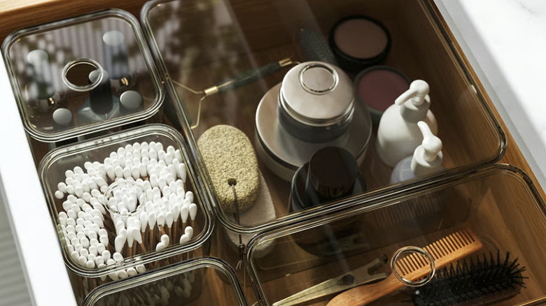 VISSLAÅN boxes with lid holding makeup, cotton swabs, hair accessories, and various other products in a drawer