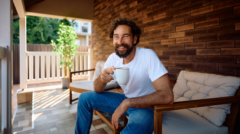 man enjoying his sunlit porch