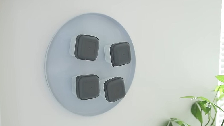 Burner cover with magnetized containers on it