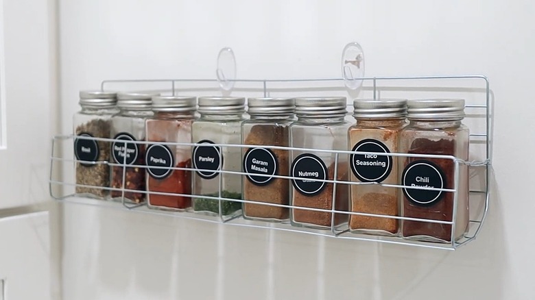 Dollar Tree cooling rack used on closet door to hold spice jars