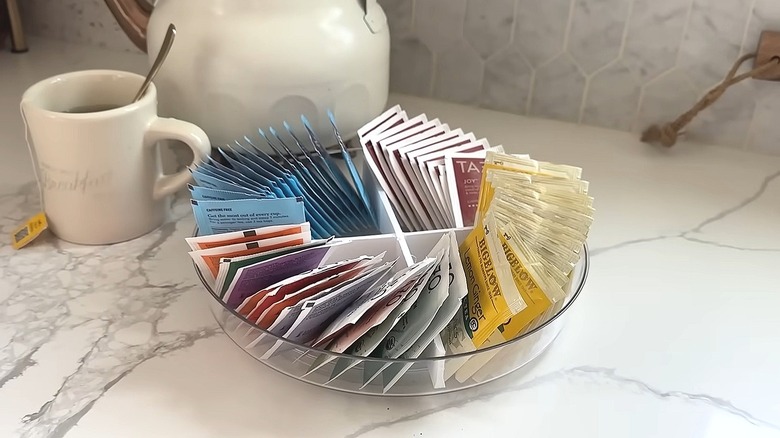 Divided lazy Susan filled with tea bags sitting on a counter