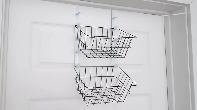 black wire baskets hanging on door hooks on a white door