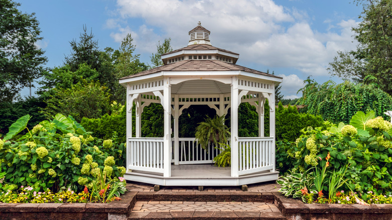 White gazebo in large garden