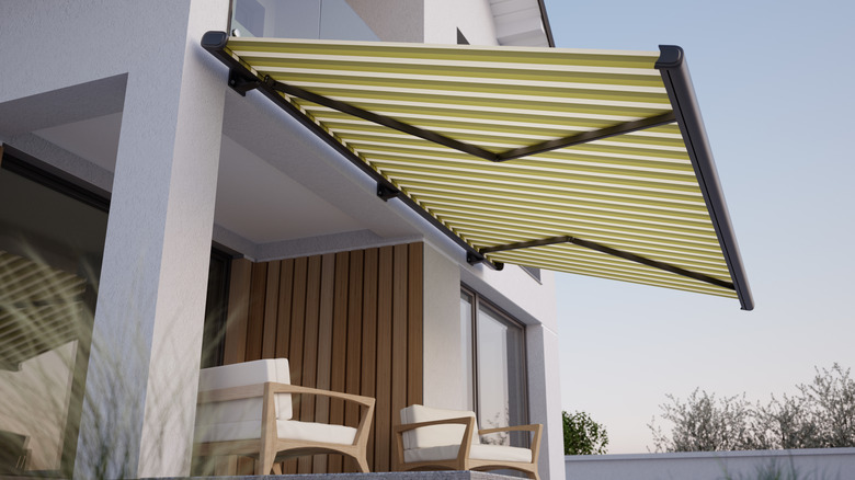 Striped green awning above outdoor seating area