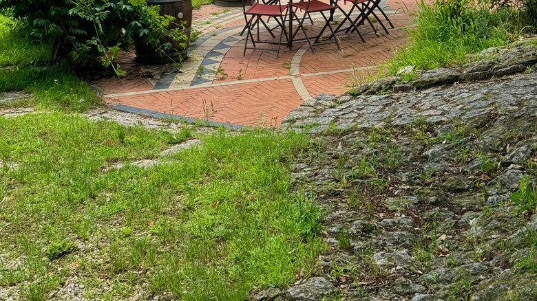 Yellow shade sail over patio furniture