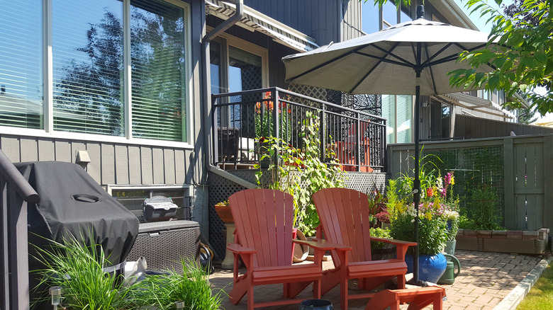 Gray umbrellas over red deck chairs