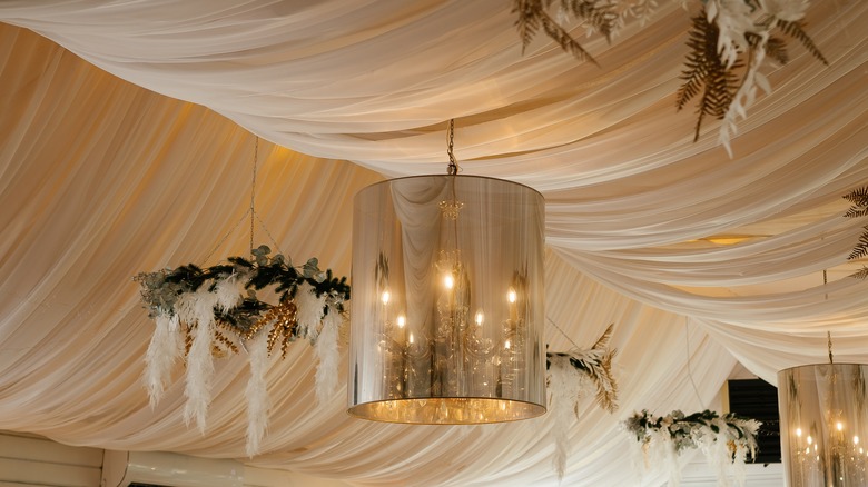 Close up of a draped ceiling with chandeliers