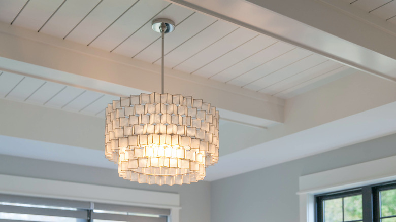 Close up of chandelier with shiplap ceiling
