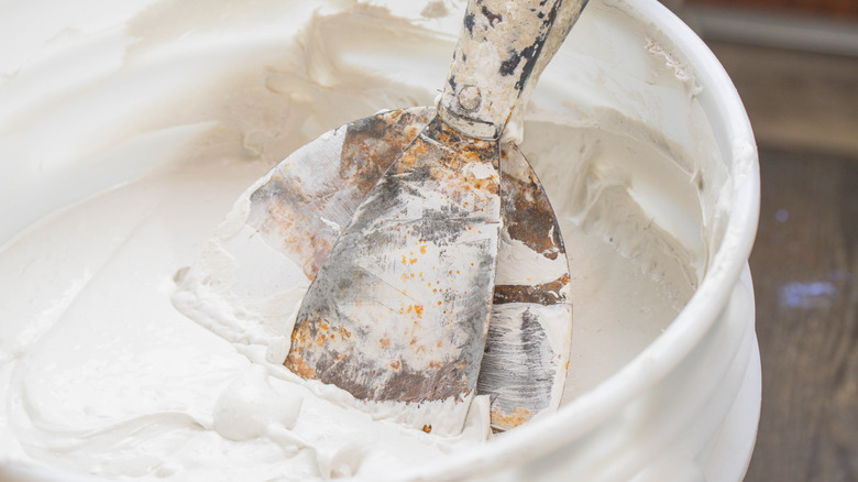 Close up of joint compound on tool