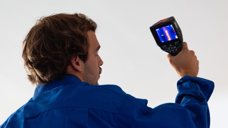 Man inspecting ceiling