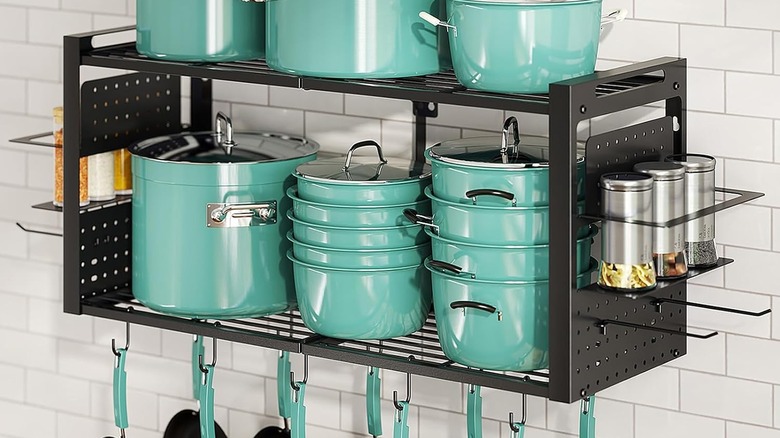 Freexployer's 2-Tier Pot Rack filled with green cookware, plus ingredients in the spice racks