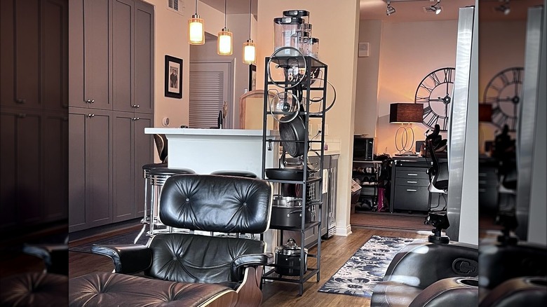 A shot of MAHANCRIS' 4-Tier Pot Rack in a living room, loaded with pots and lids