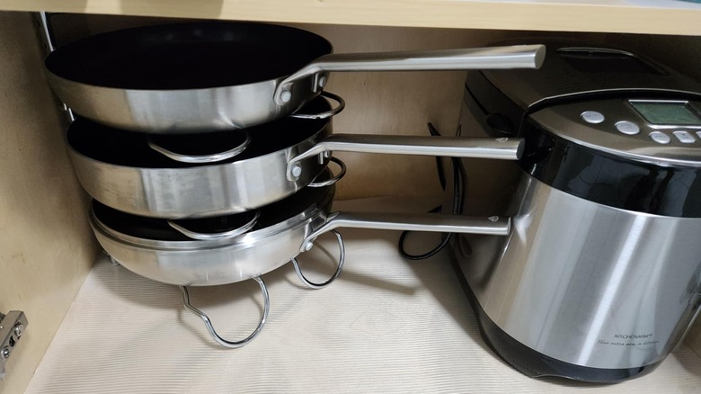 A shot of a cabinet with pans organized on CAXXA's metal pan rack