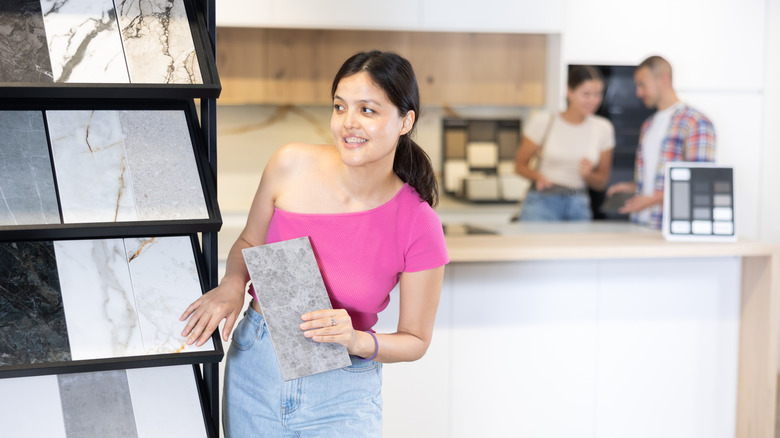 A young woman shops for tiles