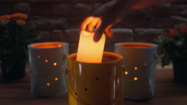 Person putting LED candle into DIY lantern