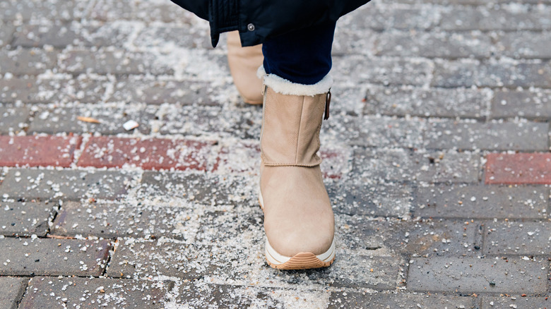 Winter boots walking through de-icing salt