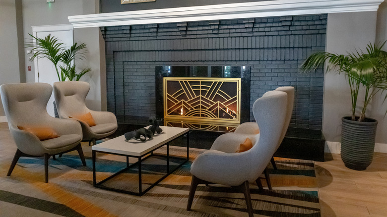 sitting area with decorative golden fireplace screen