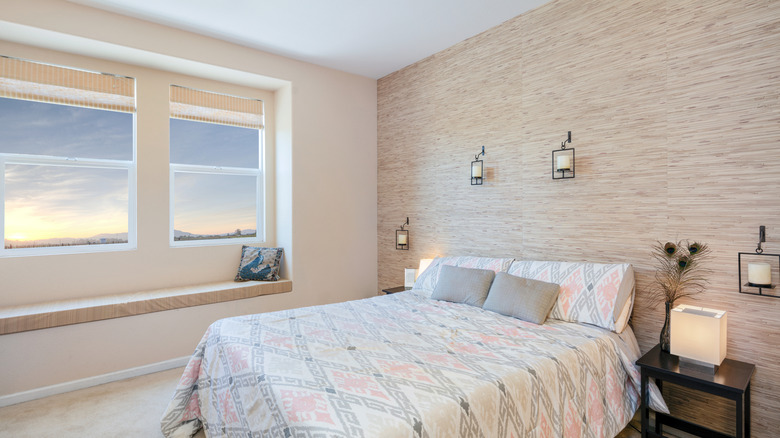 Bedroom with textured fiber wallpaper accent wall