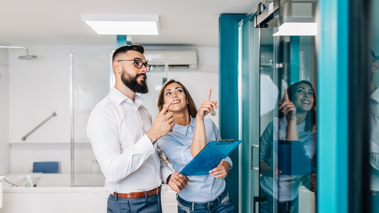 people examining barn-style shower doors