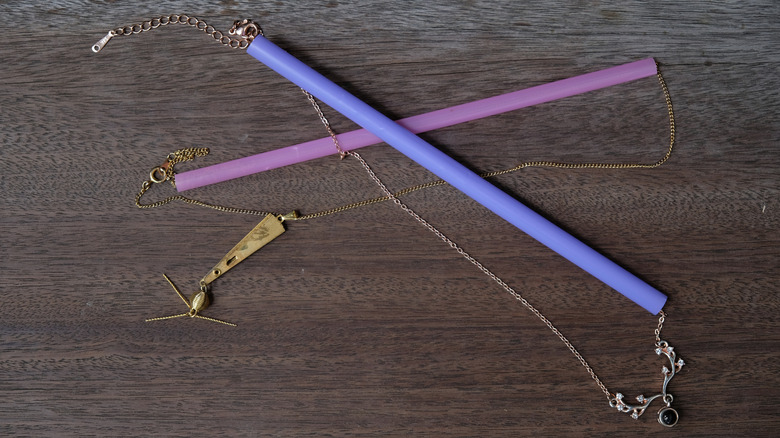Closeup of a necklaces clasped through straws