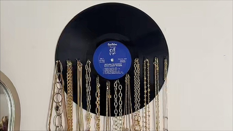 Record with hooks and hanging necklaces