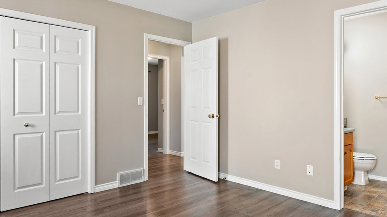 builder-grade white door in empty bedroom