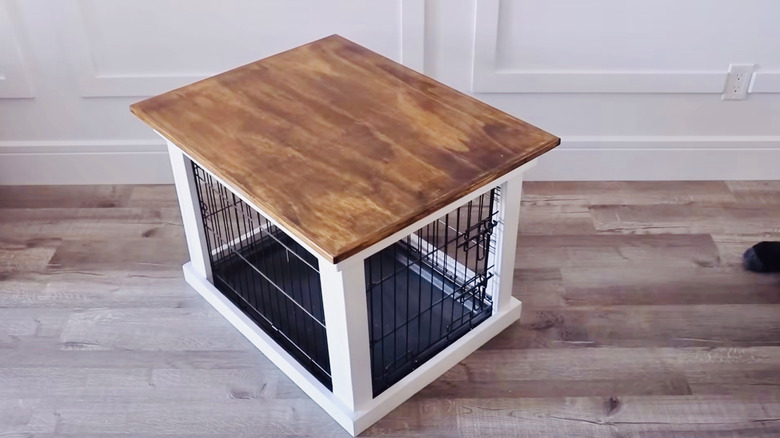 Traditional kennel's appearance is improved with a wood frame and top cover.