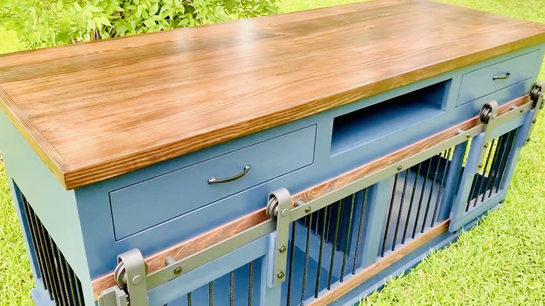 Entertainment-center kennel offers barn-style doors, drawers, and a spot for DVR or game console