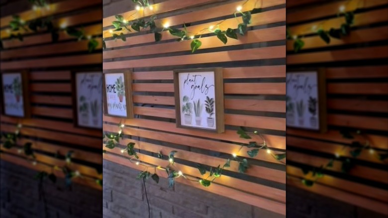 DIY wooden privacy screen to cover electrical boxes with lights and decorations