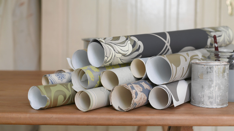 Rolls of wallpaper sitting out on a counter.