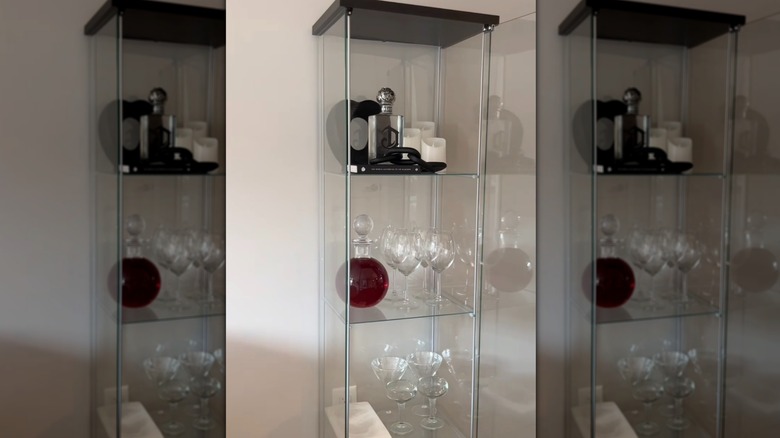 Glass display cabinet turned into a mini home bar storage unit