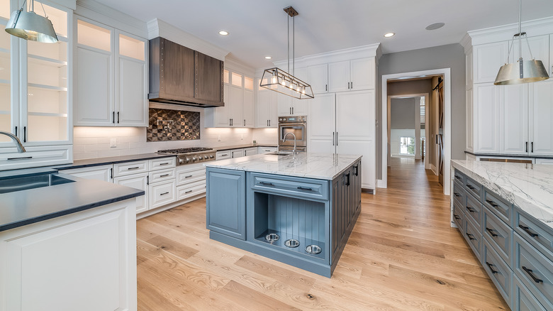 A large kitchen with wood floors