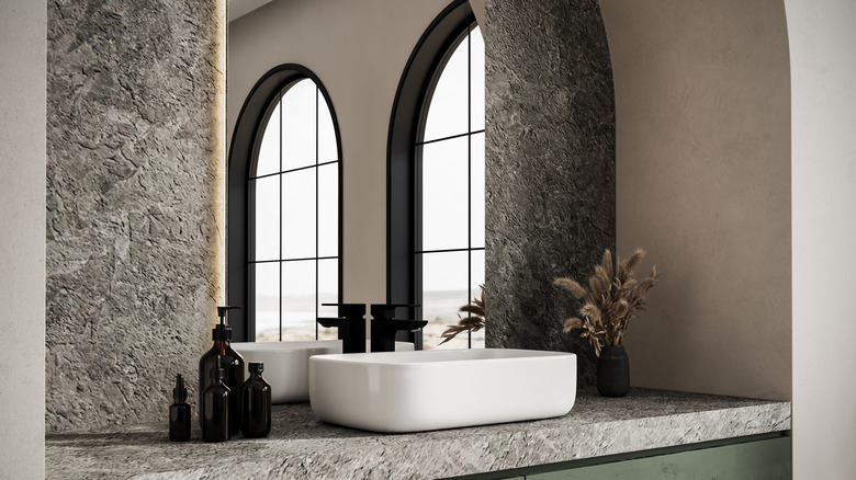 A bathroom with a stone counter and walls